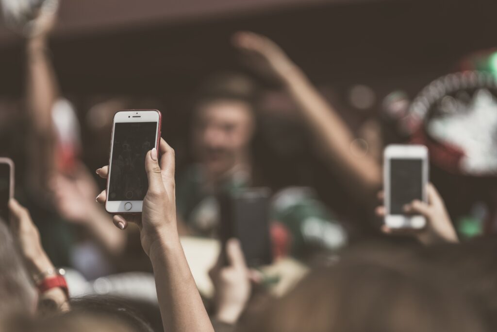 Iphones taking photos of the ceremony.